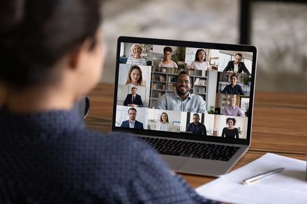 Rear view of woman talk on video call with colleagues